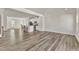 Bright, open-concept living area leads to a modern kitchen with white cabinetry and an island at 1723 Starlit Sky Ln, Cary, NC 27519