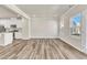 Spacious living area with natural light flowing into the attached kitchen with white cabinets at 1723 Starlit Sky Ln, Cary, NC 27519