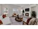 Stylish living room featuring a fireplace, neutral tones, and ample natural light at 1723 Starlit Sky Ln, Cary, NC 27519