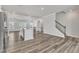 Open concept living space featuring wood floors, stairs, an island bar, and lots of natural light at 1723 Starlit Sky Ln, Cary, NC 27519