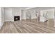 Open-concept living room boasts wood floors and a cozy fireplace for a modern living space at 1723 Starlit Sky Ln, Cary, NC 27519