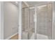 Close-up of tiled shower with glass door and built-in seat in primary bathroom at 1723 Starlit Sky Ln, Cary, NC 27519