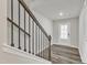 Inviting stairway with wood floors, iron railings, and natural light creates a warm and welcoming entrance at 1723 Starlit Sky Ln, Cary, NC 27519