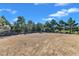 Large vacant lot surrounded by trees and a wooden fence at 1723 Starlit Sky Ln, Cary, NC 27519