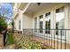 Private back patio area, featuring stone tile, white-trimmed doors, and a small fence at 1800 Pierre Pl, Apex, NC 27502