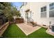 Home's backyard featuring a patio, artificial turf, and a privacy fence at 1800 Pierre Pl, Apex, NC 27502