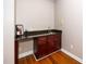 Wet bar featuring granite countertops, ample cabinet space, and hardwood flooring at 1800 Pierre Pl, Apex, NC 27502