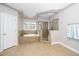 Well-lit bathroom featuring a soaking tub, walk-in shower, and tile flooring at 1800 Pierre Pl, Apex, NC 27502
