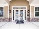 Grand entrance featuring double doors, stone accents, and stylish lighting fixtures at 1800 Pierre Pl, Apex, NC 27502