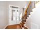 Welcoming entryway featuring a hardwood floor, a glass door and stairway with rod iron at 1800 Pierre Pl, Apex, NC 27502