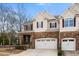 Charming townhome featuring a stone facade, two-car garage, and well-maintained landscaping at 1800 Pierre Pl, Apex, NC 27502