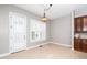 Breakfast nook area adjacent to the kitchen with a window and an exterior door at 1800 Pierre Pl, Apex, NC 27502