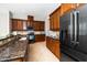 Kitchen showcasing dark cabinets, granite countertops, and stainless steel appliances at 1800 Pierre Pl, Apex, NC 27502