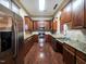 Chef's kitchen features stainless steel appliances, granite counters, and custom cabinetry at 1800 Pierre Pl, Apex, NC 27502