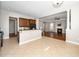 Open concept kitchen showcases a granite countertop, and an adjacent living room with fireplace at 1800 Pierre Pl, Apex, NC 27502