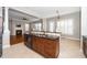 Kitchen featuring a central island with sink and a view to the living room and breakfast nook at 1800 Pierre Pl, Apex, NC 27502