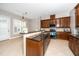 Kitchen featuring granite countertops, stainless steel appliances, and wood cabinets at 1800 Pierre Pl, Apex, NC 27502