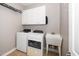 Bright laundry room with modern washer, dryer, sink and cabinet space at 1800 Pierre Pl, Apex, NC 27502