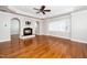 Open living room with hardwood floors, recessed lighting, a ceiling fan, and a fireplace at 1800 Pierre Pl, Apex, NC 27502