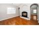 Comfortable living room with fireplace, hardwood flooring, and natural light at 1800 Pierre Pl, Apex, NC 27502