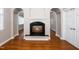 Bright living room featuring a fireplace, hardwood floors, and arched doorways at 1800 Pierre Pl, Apex, NC 27502