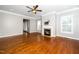 Hardwood floors and fireplace accent this bright living room, enhanced by plantation shutters at 1800 Pierre Pl, Apex, NC 27502