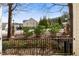 View of well-maintained neighborhood with wrought iron fencing, mature trees, and landscaped yards at 1800 Pierre Pl, Apex, NC 27502