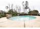Community swimming pool surrounded by privacy hedges and tall trees at 1800 Pierre Pl, Apex, NC 27502
