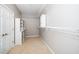 Bright, carpeted walk-in closet with white shelving and ample storage space at 1800 Pierre Pl, Apex, NC 27502