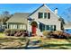 Charming Cape Cod-style home featuring a bright red door and well-maintained landscaping at 1922 Oxford Rd, Henderson, NC 27536