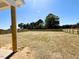 A large, seeded backyard featuring a newly constructed wooden fence, surrounded by trees at 20 Eagle Crest Court Way # Holly Farmhouse, Lillington, NC 27546