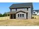 Backyard featuring a newly constructed home with a wooden fence and seeded yard at 20 Eagle Crest Court Way # Holly Farmhouse, Lillington, NC 27546