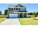 Charming two-story home features a modern gray exterior and a well-manicured lawn at 20 Eagle Crest Court Way # Holly Farmhouse, Lillington, NC 27546