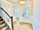 Welcoming foyer with staircase, wainscoting and view to front door at 20 Eagle Crest Court Way # Holly Farmhouse, Lillington, NC 27546