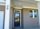 Close-up of the front entry featuring a black front door and gray brick at 20 Eagle Crest Court Way # Holly Farmhouse, Lillington, NC 27546