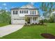 Beautiful two-story home with manicured lawn, driveway, and attached two-car garage at 20 Eagle Crest Court Way # Holly Farmhouse, Lillington, NC 27546