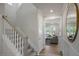Hallway with stairs leading to a bright living room with large windows at 20 Eagle Crest Court Way # Holly Farmhouse, Lillington, NC 27546