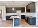 Well-designed kitchen boasts stainless appliances, gray cabinets, and center island at 20 Eagle Crest Court Way # Holly Farmhouse, Lillington, NC 27546