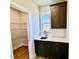 Mudroom with cabinets, sink and view of pantry with adjustable metal shelving at 20 Eagle Crest Court Way # Holly Farmhouse, Lillington, NC 27546