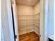 Walk-in pantry with adjustable metal shelving and wood floor at 20 Eagle Crest Court Way # Holly Farmhouse, Lillington, NC 27546