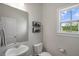 Cozy powder room featuring a round sink, a toilet, and a framed art on the wall at 20 Eagle Crest Court Way # Holly Farmhouse, Lillington, NC 27546