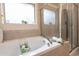 Soaking tub with tile surround, and adjacent glass-enclosed shower at 207 Kinnakeet Dr, Durham, NC 27704