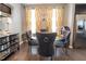 Elegant dining room featuring a round glass table, velvet chairs, stylish decor, and ample natural light at 207 Kinnakeet Dr, Durham, NC 27704