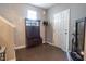 Inviting entryway with wood floors, a storage bench with coat rack, and a decorative water feature at 207 Kinnakeet Dr, Durham, NC 27704