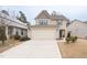 Charming two-story home featuring a two-car garage, neutral siding, and well-maintained landscaping at 207 Kinnakeet Dr, Durham, NC 27704