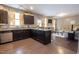 Open kitchen concept with dark cabinets, stainless appliances, granite counters, and seamless flow to living area at 207 Kinnakeet Dr, Durham, NC 27704
