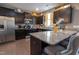 Modern kitchen with dark cabinetry, stainless steel appliances, granite countertops, and wood flooring at 207 Kinnakeet Dr, Durham, NC 27704