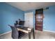 Comfortable office features light blue walls, neutral carpet, and a dark computer desk at 207 Kinnakeet Dr, Durham, NC 27704