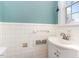 Bathroom featuring white tile, a sink, and a window at 2110 Cokey Rd, Rocky Mount, NC 27801