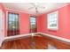 Bright bedroom featuring hardwood floors, soft pink walls, and natural light from two windows at 2110 Cokey Rd, Rocky Mount, NC 27801